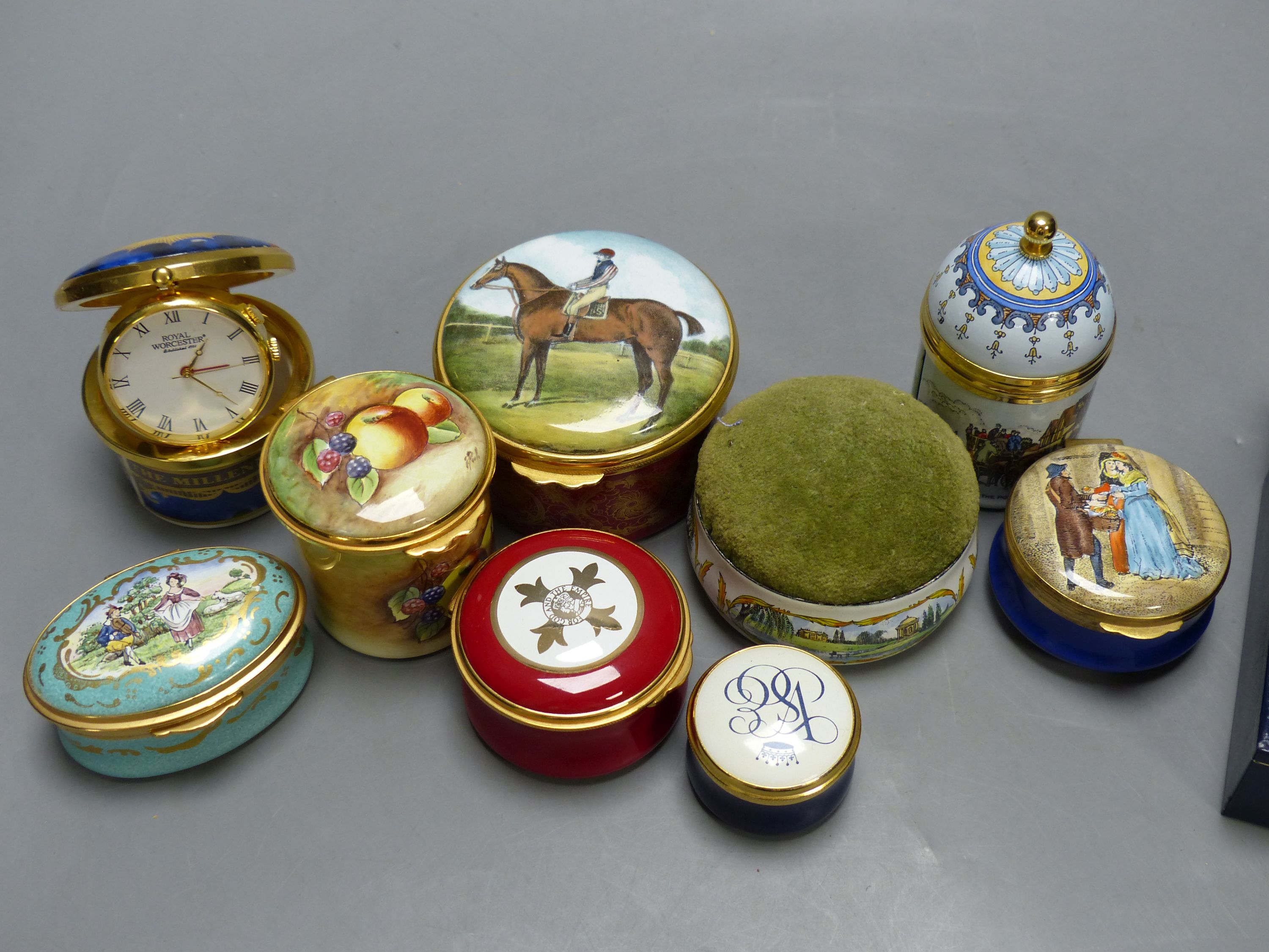 Nine enamelled boxes (one containing a watch, one with musical movement) and a similar pin cushion (10)